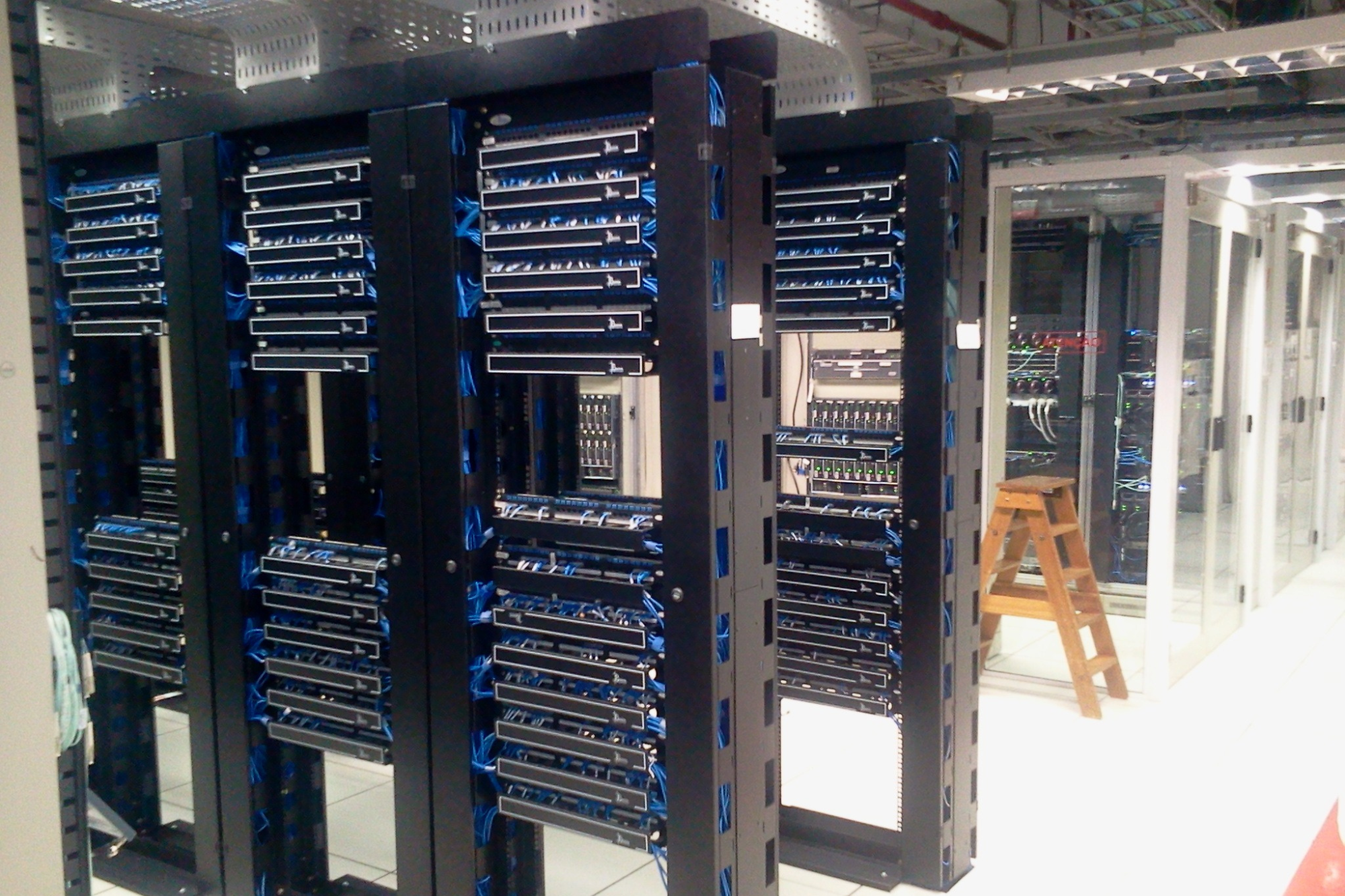 A small business office with remote employees, computers, servers, and network devices being monitored and managed by a centralized SOC team