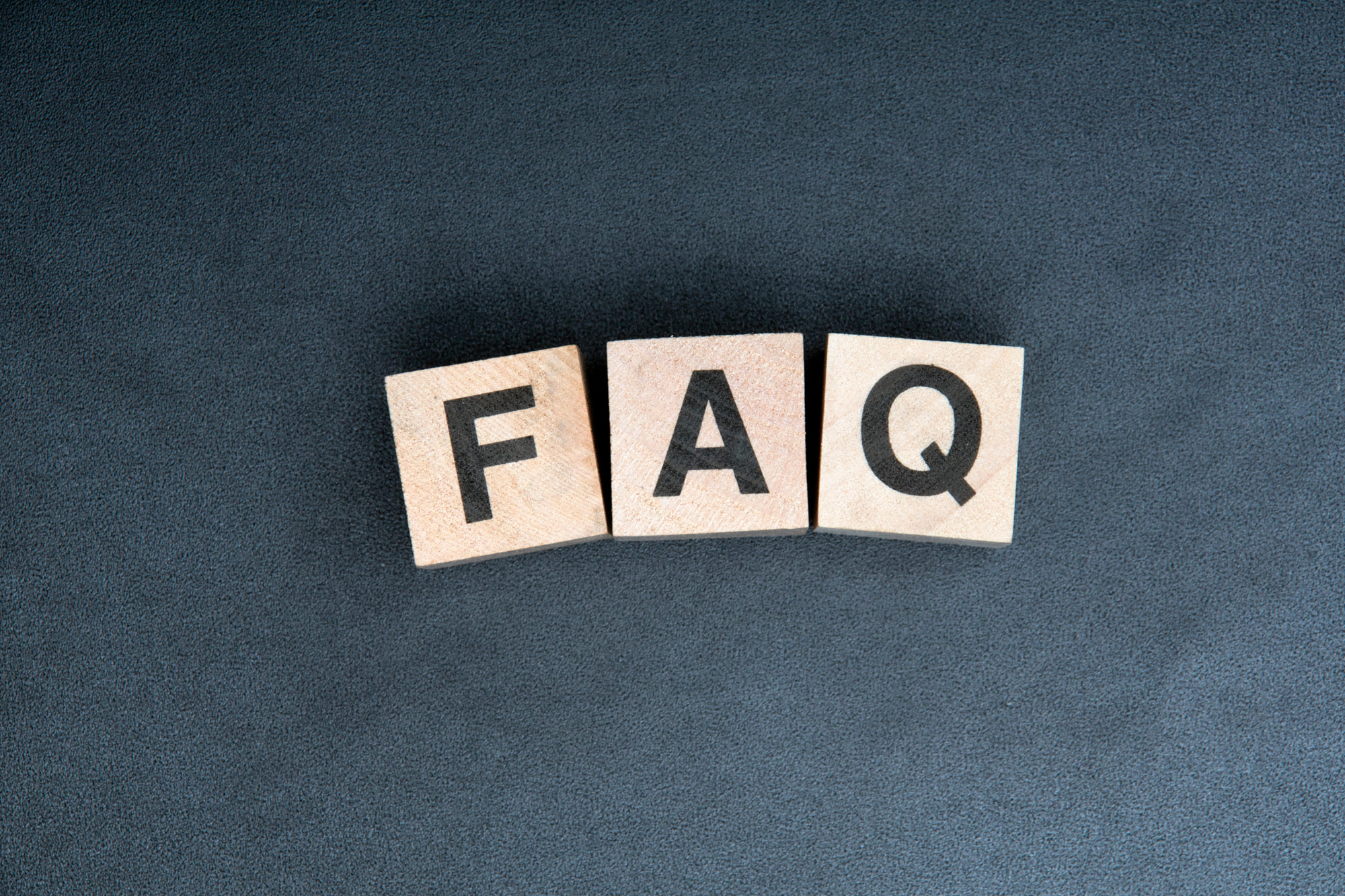 A small business owner outsources frequently asked questions to a remote team, showing a computer screen with a virtual meeting and a globe symbolizing global reach