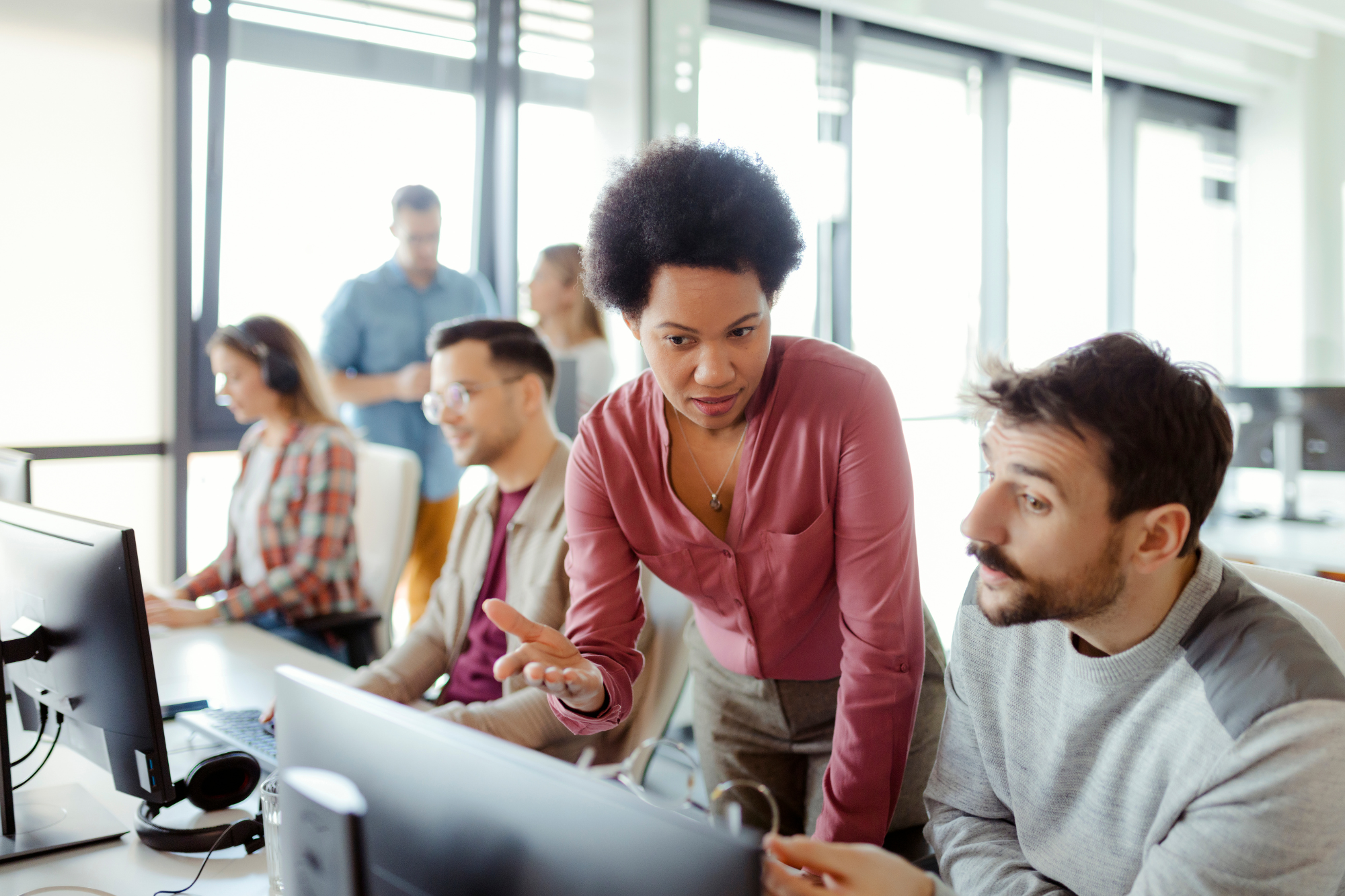 A small business owner providing cybersecurity training to remote employees via video conference