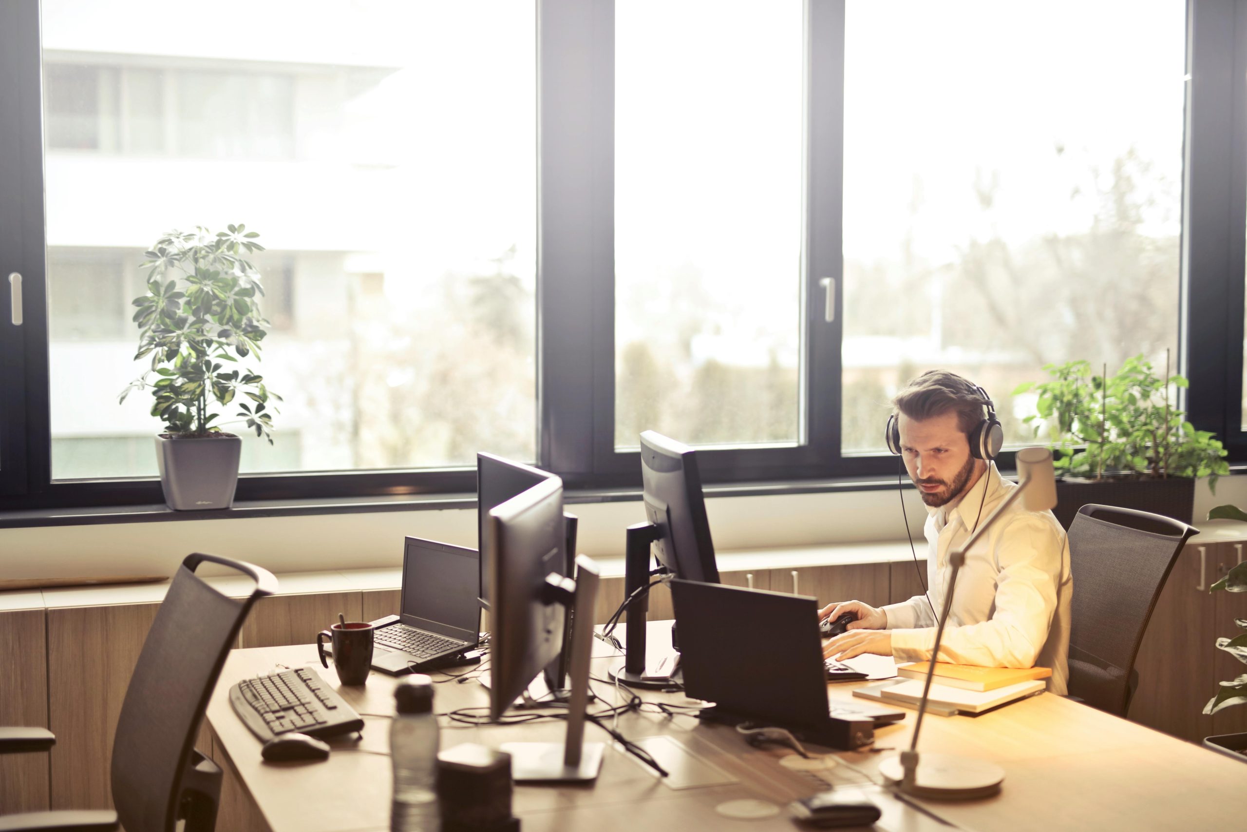 A small business owner working remotely while a managed service provider optimizes business processes