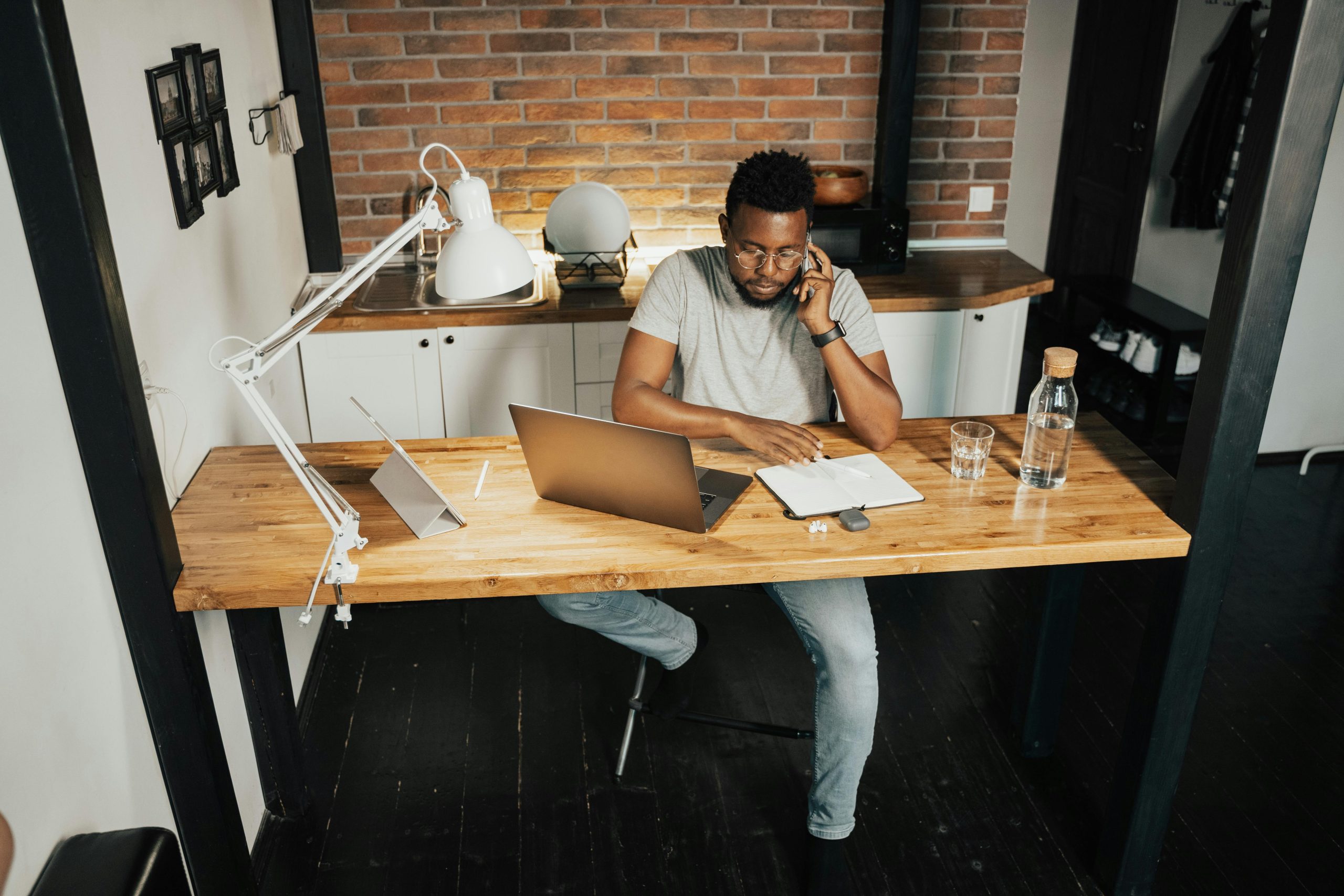 A small business owner reviewing options from different MSPs, with a laptop and paperwork spread out on a desk