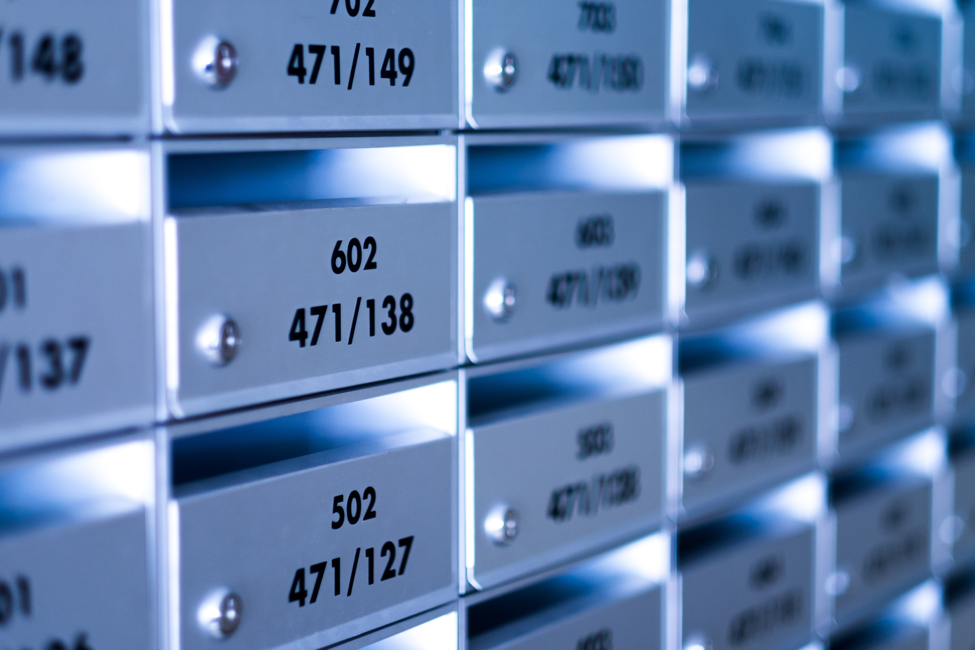 A locked mailbox with a shield and padlock symbol, surrounded by a glowing force field