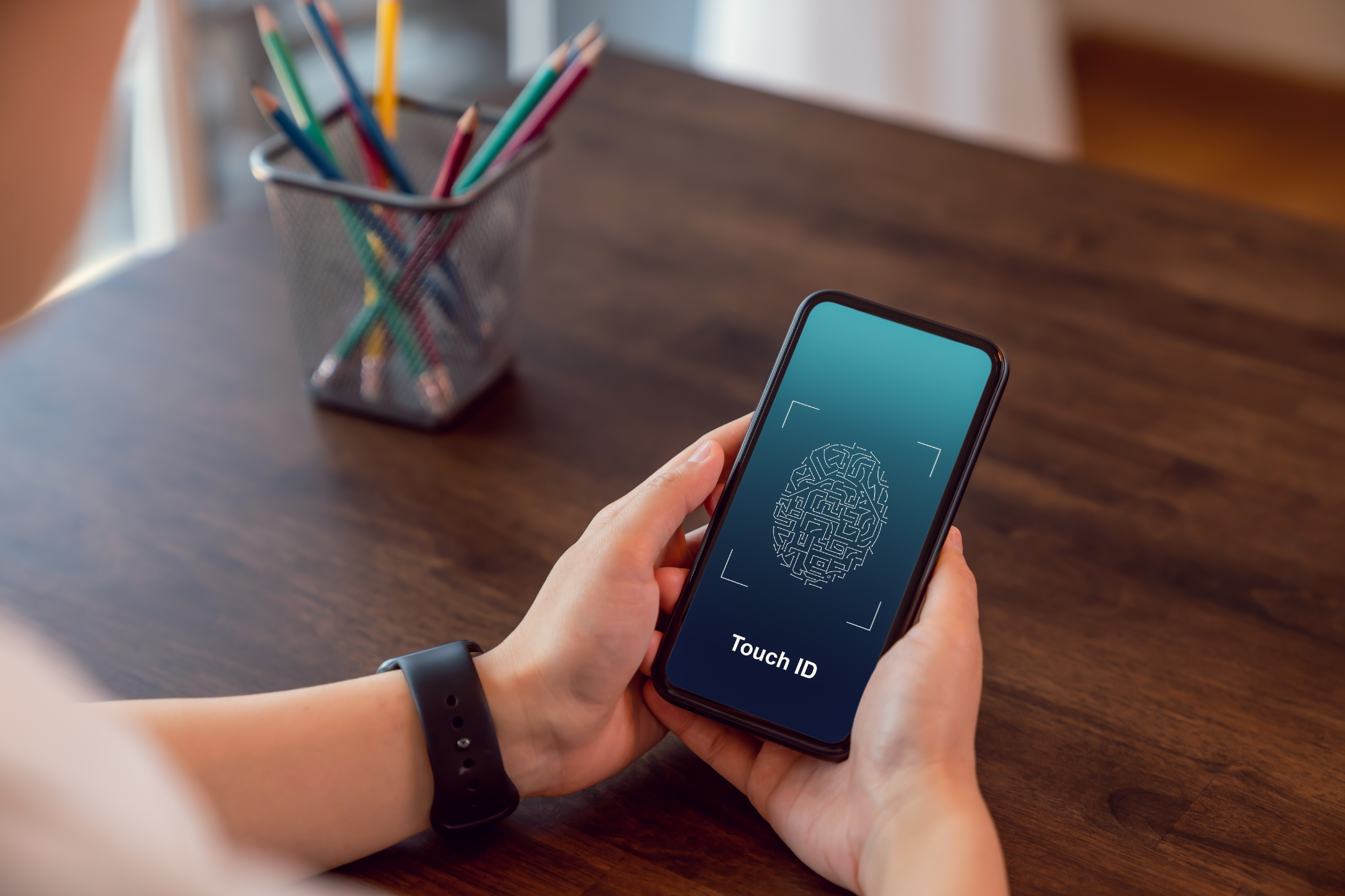 A smartphone with a security app open, a fingerprint scanner, and a physical key nearby